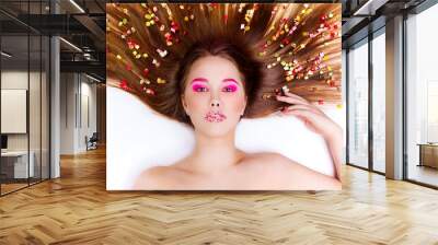 Candy Themed Styled Girl with Brown Hair in Studio on White Wall mural