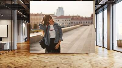 Fashionably dressed woman on the streets of a European city on the summer day Wall mural