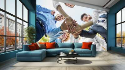 Business people standing in circle holding hands together Wall mural