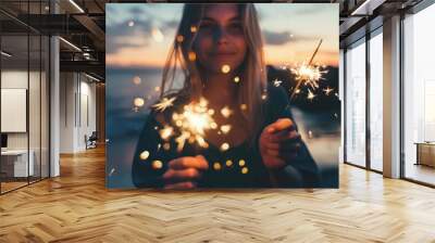 A woman holds a sparkler Wall mural