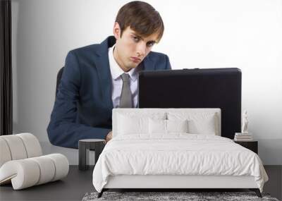 sleepy young caucasian businessman on desk with laptop Wall mural