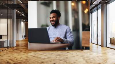 Candid portrait of an African American man working on a laptop in a stylish modern cafe hotel lobby, generative ai Wall mural