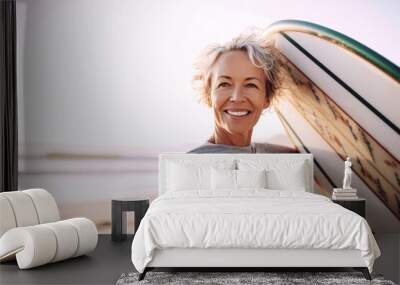 Middle-aged woman holding a surfboard on a beach, radiating vitality, optimism, health, and wellbeing, aging gracefully and embracing active lifestyle, generative ai Wall mural