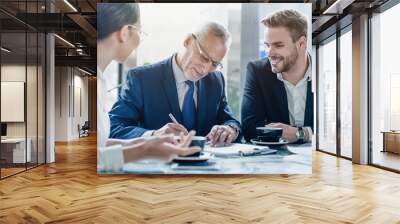 Businessman signing contract at group meeting in office. discussing contract in office. Multiethnic group of business people partners or lawyers working together. Teamwork and partnership Wall mural