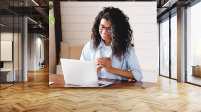 Cheerful relaxed young afro businesswoman having coffee break at work. African girl student elearning distance training course study work at home office. young,  watching online education webinar. Wall mural