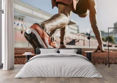 Close up of male athlete getting ready to start running on track . Focus on sneakers Wall mural