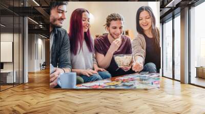 Few happy friends playing in table games indoor Wall mural