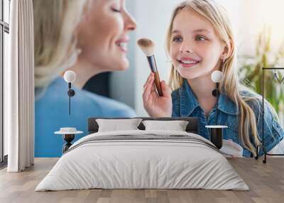 Happy loving family concept. Close up of little girl making make up her mother at home Wall mural