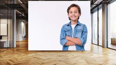 Happy young caucasian boy in casual outfit with arms crossed isolated over white background Wall mural