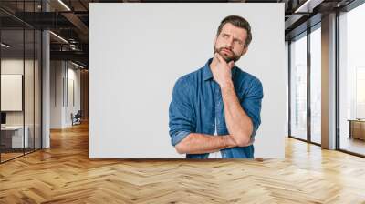 Pensive thoughtful contemplating caucasian young man thinking about future, planning new startup looking upwards isolated in white background Wall mural