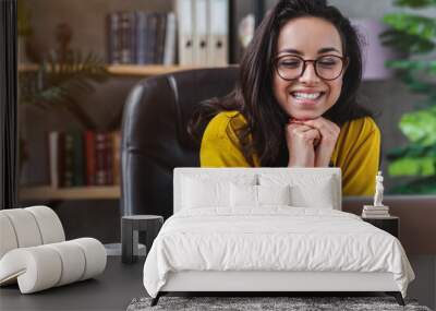 Portrait of young caucasian girl watching in laptop while working from home office Wall mural