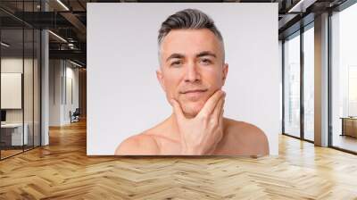 Sexy caucasian man looking into a camera shirtless isolated over white background Wall mural