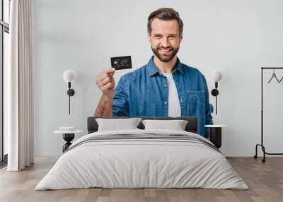 Smiling caucasian man bank client customer showing credit card for e-commerce, pay cashback, loan, e-banking isolated in white background Wall mural