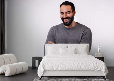 Smiling cheerful Arab man in casual clothing isolated over white background Wall mural