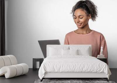 Smiling woman in casual clothes holding laptop and sending email standing over white background Wall mural