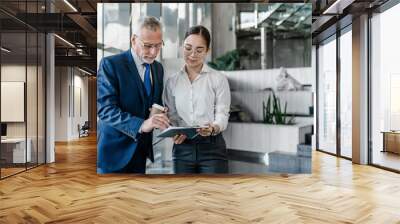 Two business people discussing about work at office stairs Wall mural