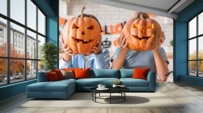 Two little kids celebrating Halloween at home kitchen Wall mural