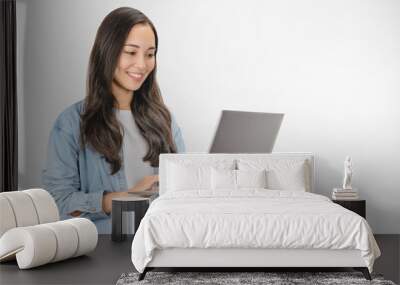 Young happy smiling woman in casual clothes holding laptop and sending email standing over white background Wall mural