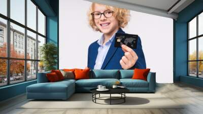 Young smart caucasian preteen boy male child kid elementary primary middle school pupil in formal clothes eyeglasses showing holding demonstrate credit bank plastic card isolated on white background Wall mural