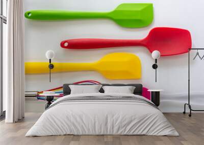 Spatulas ,whisk and cooking brush made from silicone in various color lay on white background Wall mural