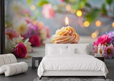 Festive cupcake with lit candle and pastel frosting, surrounded by flowers, copy space available, cupcake Wall mural