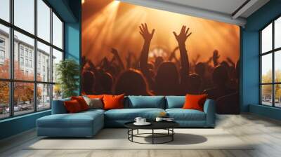 a crowd of people at a concert with their hands up in the air and lights shining down on them Wall mural