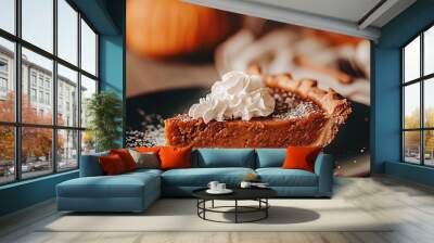 A slice of pumpkin pie with whipped cream on top. The pie is served on a black plate with a white napkin Wall mural