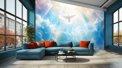 Holy Spirit dove is flying in clear blue sky, beautiful sun rays shine around. Wall mural