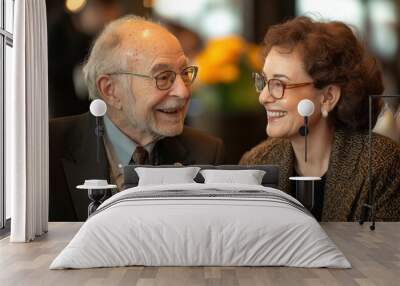 A joyful elderly couple sharing a warm moment with smiles in a modern indoor setting, capturing love and connection. Wall mural