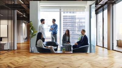 Busy diverse professional team business people workers talking in modern corporate office lobby. International coworkers group having teamwork conversation together at work meeting. Vertical shot Wall mural