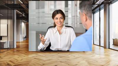 Busy happy business woman professional bank manager lawyer attorney consulting client on finances management. Female executive speaking to colleague working at office corporate meeting. Vertical. Wall mural