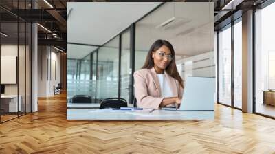 Busy professional business woman employee working looking at computer typing in office. Young African American female company finance manager executive using laptop sitting at desk. Copy space Wall mural