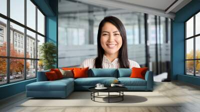 Confident smiling young professional Asian business woman corporate leader, happy japanese female employee, company sales marketing manager, standing in office, headshot portrait. Wall mural