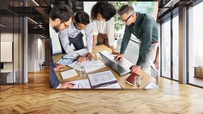 Diverse international executive business people group brainstorming at boardroom meeting table. Multiethnic team discussing project developing business strategy doing paperwork analysis in office. Wall mural