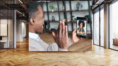 Happy african man waving hand video calling girlfriend on digital tablet. Black couple talking dating meeting virtual in conference remote relationship online distance chat, over shoulder view. Wall mural