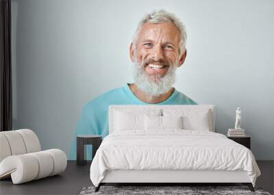 Happy mature old bearded man with dental smile, cool mid aged gray haired older senior hipster wearing blue sweatshirt standing isolated on white background looking at camera, headshot portrait. Wall mural