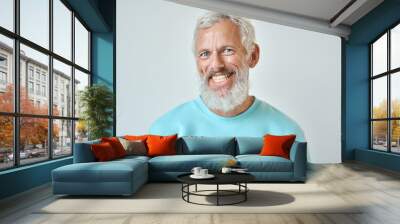 Happy mature old bearded man with dental smile, cool mid aged gray haired older senior hipster wearing blue sweatshirt standing isolated on white background looking at camera, headshot portrait. Wall mural