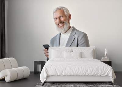 Happy old business man smiling senior mature older businessman professional wearing suit holding cell phone using smartphone mobile app online standing isolated on white background looking at camera. Wall mural