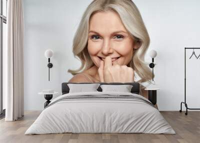 Happy smiling attractive 50s middle aged blonde woman looking at camera advertising antiage face skin and aging hair care treatment and cosmetics isolated on white background. Close up portrait. Wall mural