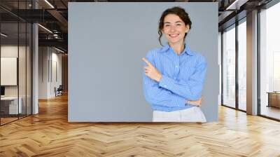 happy young smiling professional business woman wearing blue shirt looking at camera pointing finger Wall mural