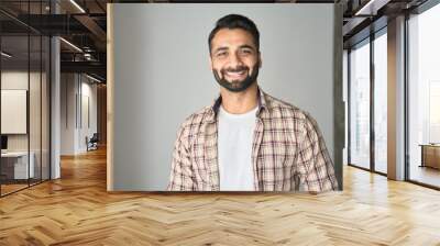 Headshot portrait of attractive confident indian Hispanic man with toothy smile looking at camera at modern living room. Latin businessman posing in casual stylish look at home office. Wall mural