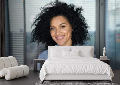 Headshot portrait of confident smiling successful African American businesswoman executive top manager looking at camera posing in modern contemporary corporate office. Business corporate concept. Wall mural