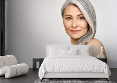 Portrait of gorgeous happy middle aged mature asian woman, senior older 50s lady pampering her hair looking at camera isolated on white. Ads of anti age skin and hair care spa. Copy space. Wall mural