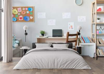 School child room interior space with table, couch, bookcase, books and laptop on table indoors at home apartment background. Children homeschool, online distance remote virtual learning, banner. Wall mural