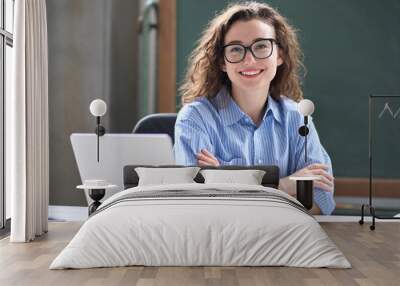 Young happy business woman sitting at work desk with laptop. Smiling school professional online teacher coach advertising virtual distance students classes teaching remote education webinars. Portrait Wall mural