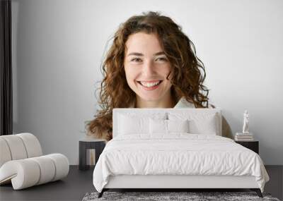 Young smiling positive woman, happy curly joyful cheerful girl student laughing, looking at camera standing isolated at white background, advertising products and services, close up headshot portrait. Wall mural