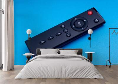 Remote control TV or radio isolated on blue background with selective focus and crop fragment Wall mural