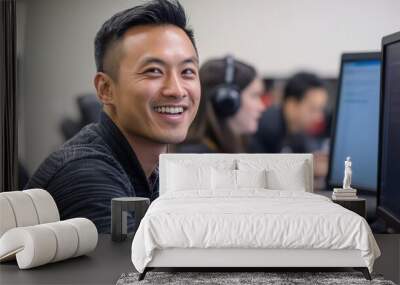 A Smiling Man Uses a Computer in a Modern Office Wall mural