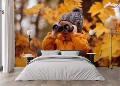 Young Boy in Yellow Jacket Using Binoculars in Autumn Forest Wall mural