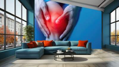 Targeted therapy techniques for sports injury recovery and pain relief featuring hands massaging a swollen bruised knee joint to promote healing and rehabilitation Wall mural